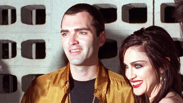 FILE - Madonna poses with her brother, Christopher Ciccone, left, and director Alek Keskishian following the premiere showing of Madonna's newest film, "Truth or Dare," May 7, 1991, in the Hollywood section of Los Angeles. (AP Photo/Julie Markes, File)