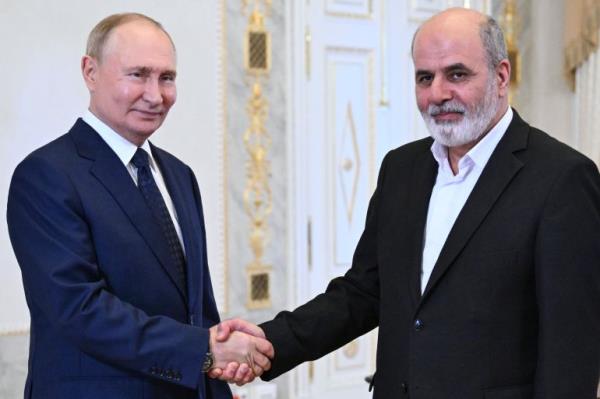 Russian President Vladimir Putin, left, and Iranian Supreme National Security Council Secretary Ali Akbar Ahmadian, right, shake hands during their meeting on the sidelines of the BRICS and BRICS Plus High-Level Security Officials meeting in St. Petersburg, Russia, Thursday, Sept. 12, 2024. (Kristina Kormilitsyna, Sputnik, Kremlin Pool Photo via AP)